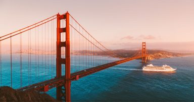 The Golden Date Bridge, with a cruise ship sailing underneath it.