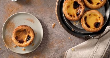 Traditional Portuguese custard tarts on plates.